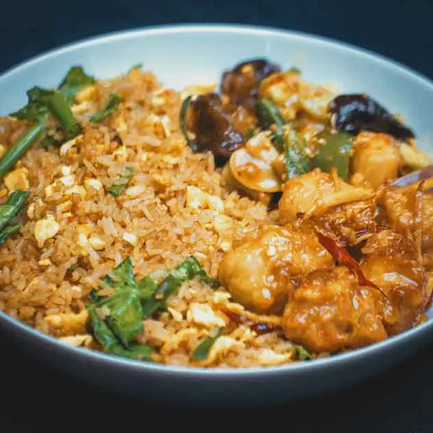 Ginger Chicken Rice BowlEgg Fried Rice Served with Soy Glazed Ginger Chicken, Mushroom & Baby Corn