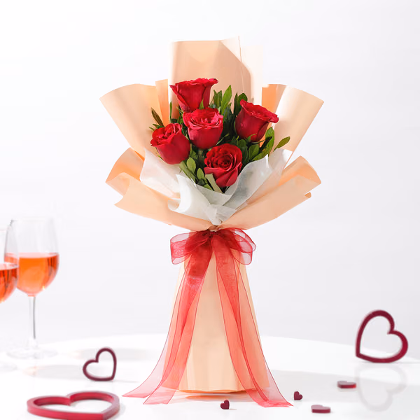 fresh-red-roses-wrapped-in-peach-sheets